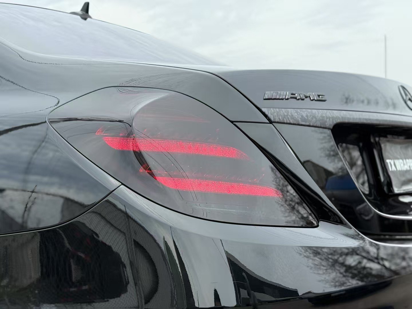 Vehicle light protection film with red illuminated lens detail